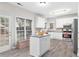 Bright, modern kitchen with white cabinetry, stainless steel appliances, and a central island with granite countertop at 1224 Indian Hills Pkwy, Marietta, GA 30062