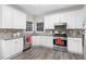 Bright kitchen with white cabinetry, stainless steel appliances, and mosaic backsplash at 1224 Indian Hills Pkwy, Marietta, GA 30062