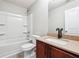 Bright bathroom featuring a shower-tub combo and a vanity with a granite-look countertop at 1241 To Lani Path, Stone Mountain, GA 30083
