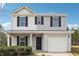 Charming two-story home with a welcoming front porch and neatly landscaped front yard at 1241 To Lani Path, Stone Mountain, GA 30083