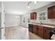 Open kitchen features dark wood cabinets, modern appliances, and an adjacent dining area at 1241 To Lani Path, Stone Mountain, GA 30083