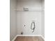 Laundry room with gray walls, white trim, wood-look flooring, and a wire shelf at 1241 To Lani Path, Stone Mountain, GA 30083