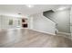 Open-concept living area with stylish flooring connecting the living room to the dining area and kitchen at 1241 To Lani Path, Stone Mountain, GA 30083