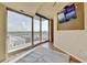 Bright bedroom boasts a large window with stunning city views and a wall-mounted television at 361 17Th Nw St # 1021, Atlanta, GA 30363