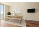 Cozy dining area with wood table, bench, chairs, and TV at 361 17Th Nw St # 1021, Atlanta, GA 30363
