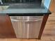 Stainless steel dishwasher set against granite countertops and wooden cabinetry at 361 17Th Nw St # 1021, Atlanta, GA 30363
