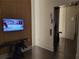 Stylish hallway with wood accent wall, TV, modern console table, and a mirrored elevator at 361 17Th Nw St # 1021, Atlanta, GA 30363