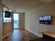 Open-concept living room features a mounted television and balcony access with beautiful city views at 361 17Th Nw St # 1021, Atlanta, GA 30363