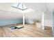 Bright attic space featuring a skylight, built-in storage, and light hardwood floors at 3051 Habersham Nw Rd, Atlanta, GA 30305