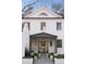 Classic white home featuring a covered porch with decorative lattice and manicured landscaping at 3051 Habersham Nw Rd, Atlanta, GA 30305