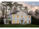 Stately white home with elegant design, well-lit windows, and beautifully landscaped front yard at 3051 Habersham Nw Rd, Atlanta, GA 30305