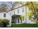 Charming white home with a covered front porch, featuring green accents and lush green lawn at 3051 Habersham Nw Rd, Atlanta, GA 30305
