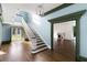 Spacious foyer with staircase, hardwood floors, elegant lighting, and view into the living room at 3051 Habersham Nw Rd, Atlanta, GA 30305