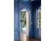 Elegant hallway features arched doorway and blue paneled walls and a wood floor at 3051 Habersham Nw Rd, Atlanta, GA 30305