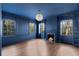 Elegant living room featuring a fireplace, wood floors, and windows with wooded views at 3051 Habersham Nw Rd, Atlanta, GA 30305