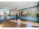 Bright living room with paneled walls, mural, hardwood floors, and natural light at 3051 Habersham Nw Rd, Atlanta, GA 30305