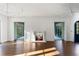 Bright living room featuring a marble fireplace, hardwood floors, and views to an outdoor sitting room at 3051 Habersham Nw Rd, Atlanta, GA 30305