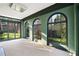 Bright sun room with large windows offers views of the landscaped backyard at 3051 Habersham Nw Rd, Atlanta, GA 30305