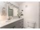 Bathroom features a sink with gray cabinets, quartz countertops, and a modern lighted mirror at 3529 Essex Ave # 75, Atlanta, GA 30339