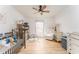 Cozy bedroom with a ceiling fan, light wood-look floors, and plenty of natural light at 3529 Essex Ave # 75, Atlanta, GA 30339