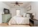 Inviting bedroom with a ceiling fan, light wood-look floors, and two windows at 3529 Essex Ave # 75, Atlanta, GA 30339