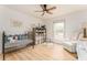 Comfortable bedroom with a ceiling fan, light wood-look floors, and plenty of natural light at 3529 Essex Ave # 75, Atlanta, GA 30339