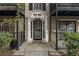 Stylish condo entrance featuring a classic white door with decorative columns and black iron railings at 3529 Essex Ave # 75, Atlanta, GA 30339