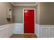 Inviting entryway featuring a bright red door, white wainscoting, and a cheerful welcome mat at 3529 Essex Ave # 75, Atlanta, GA 30339