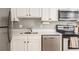 Modern kitchen featuring stainless steel appliances, elegant backsplash, and white cabinetry at 3529 Essex Ave # 75, Atlanta, GA 30339