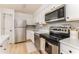 Well-maintained kitchen with stainless steel appliances, white cabinets, and modern backsplash at 3529 Essex Ave # 75, Atlanta, GA 30339