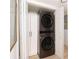 Stacked washer and dryer unit in a hall closet with storage at 3529 Essex Ave # 75, Atlanta, GA 30339