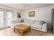 Comfortable living room with a sectional sofa, wood floors, and views of the patio through French doors at 3529 Essex Ave # 75, Atlanta, GA 30339