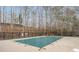 Outdoor pool with a safety cover surrounded by a deck and trees at 3529 Essex Ave # 75, Atlanta, GA 30339