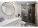 Bathroom featuring a round mirror, vanity, and glass-enclosed shower at 3655 Habersham Ne Rd # 226-A, Atlanta, GA 30305