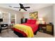 Bright bedroom with ceiling fan, desk, and colorful bedding at 3655 Habersham Ne Rd # 226-A, Atlanta, GA 30305