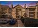Attractive multi-story condo building featuring balconies and manicured landscaping at dusk at 3655 Habersham Ne Rd # 226-A, Atlanta, GA 30305