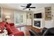 Bright living room featuring a ceiling fan, a fireplace, hardwood floors, and French doors to the outside at 3655 Habersham Ne Rd # 226-A, Atlanta, GA 30305