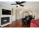 Cozy living room with hardwood floors, fireplace, built-in shelving, and an open floor plan at 3655 Habersham Ne Rd # 226-A, Atlanta, GA 30305
