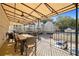 Outdoor patio with awning, dining table, and seating, overlooking parking and pool at 3655 Habersham Ne Rd # 226-A, Atlanta, GA 30305