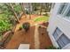 Backyard showcasing lush landscaping, stone pathway, and verdant greenery, offering a private outdoor space at 730 Glenferry Trl, Atlanta, GA 30328