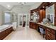 An elegant bathroom with a tub, frameless shower, and dark wood cabinets at 730 Glenferry Trl, Atlanta, GA 30328