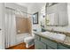 Bathroom featuring a vanity with a granite countertop, a tub-shower combo, and classic fixtures at 730 Glenferry Trl, Atlanta, GA 30328