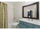 Bright bathroom with shower-tub, charming vanity, and stylish fixtures at 730 Glenferry Trl, Atlanta, GA 30328