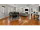 Open-concept dining area with hardwood floors, views of living room, and access to the kitchen and outdoor areas at 730 Glenferry Trl, Atlanta, GA 30328