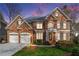Beautiful two-story brick home with a manicured front lawn and two-car garage at 730 Glenferry Trl, Atlanta, GA 30328