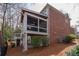 Exterior view showcasing a screened porch and deck attached to the home's brick and siding exterior at 730 Glenferry Trl, Atlanta, GA 30328