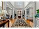 Stunning foyer with high ceilings, wood floors, a decorative rug, and access to various rooms at 730 Glenferry Trl, Atlanta, GA 30328
