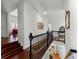 Second floor hallway showcasing dark wood floors and wrought iron railing at 730 Glenferry Trl, Atlanta, GA 30328