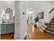 Hallway with wood floors, stairs, and a glimpse of a bathroom with a vanity and mirror at 730 Glenferry Trl, Atlanta, GA 30328