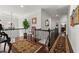 Second floor hallway with hardwood floors and wrought iron banister at 730 Glenferry Trl, Atlanta, GA 30328